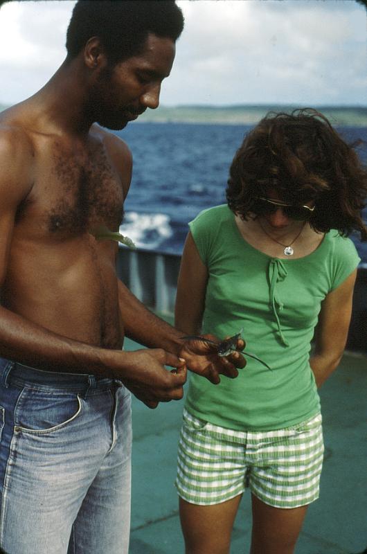 Untitled-Scanned-12_Ruth_flyingfish A crewman shows Ruth a flying fish -- which land on deck from time to time and are quite good to fry and eat.