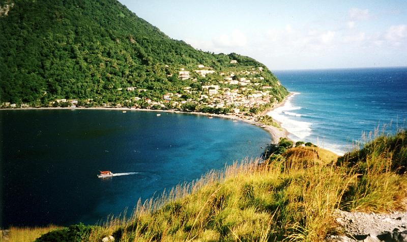 ScottsHead_ocean_bay View from Scott's Head: The village of Scott's Head with the Atlantic Ocean on the right and Scott's Head Bay, which opens to the Caribbean Sea, on the left.  A boatload of tourist snorkelers and divers is departing the bay.