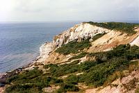1 [Wikipedia] Aquinnah is a town, formerly known as Gay Head, located on Martha's Vineyard in Dukes County, Massachusetts, USA. The population was 344 at the 2000 census. It is known for its beautiful clay cliffs and quiet natural serenity, which has become less common in the heavily populated northeastern United States. The clay cliffs/beach are one of the few nude beaches left in the U.S. More recently, it has become celebrated as a center of Wampanoag culture and a center of pride and tradition amongst members of the tribe, who make up a majority of the town's residents.