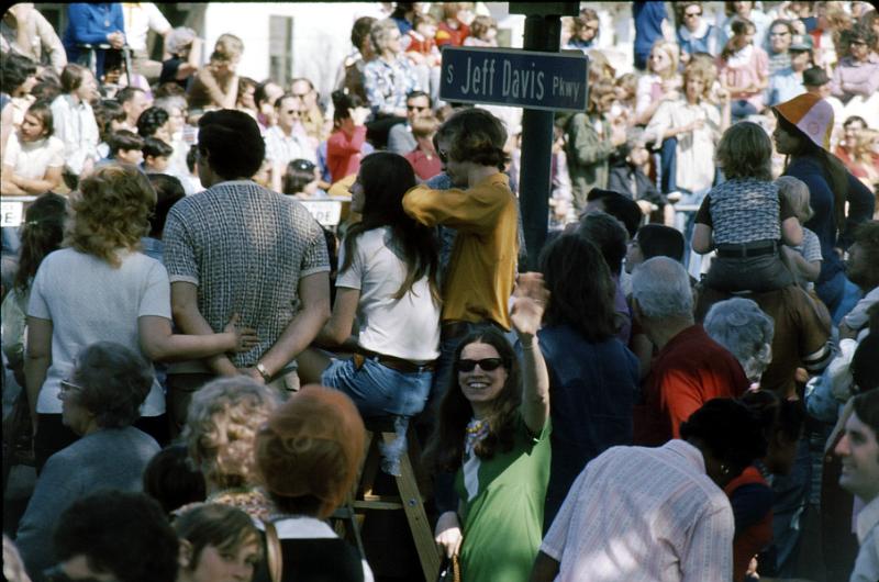 jeff_davis-04 Ruth waves to me at another parade we took in on Jeff Davis Parkway.  The parades roll down main streets and even in the suburbs, even in 1973.  My first Mardi Gras (1956), they still rolled through the French Quarter, but that became too confining.