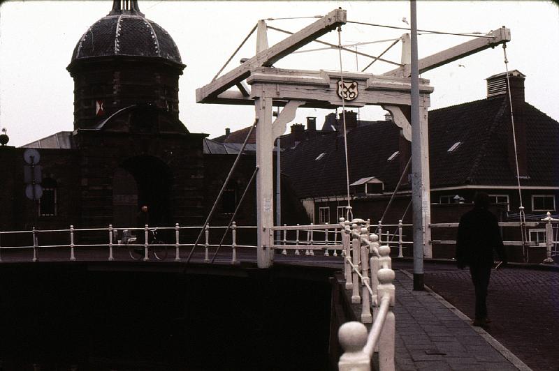 Leiden_West_Gate_over_Old_Rhein I lived in a Leiden commune for a time, and also took Ruth there in 1974. [Wikipedia]: Leiden (in English also – though now rarely – Leyden) is a city and municipality in the province of South Holland in the Netherlands. It forms a single urban area with Oegstgeest, Leiderdorp, Voorschoten, Valkenburg, Rijnsburg and Katwijk, with 254,000 inhabitants. It is located on the Old Rhine, close to the cities of The Hague and Haarlem.

Leiden is also the birthplace of Rembrandt and a university town since 1575, and famed for the Leiden Jar (a capacitor that stored static electricity).  Also, the Pilgrims, led by John Robinson, first settled in Leiden, but left because their children were becoming too like the Dutch.