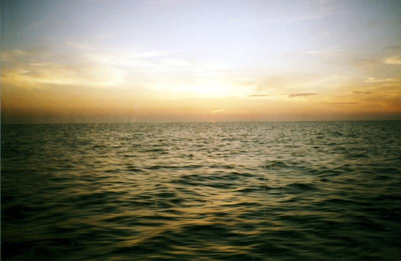 12 On our ferry back. The sun is just slipping below the horizon (center).