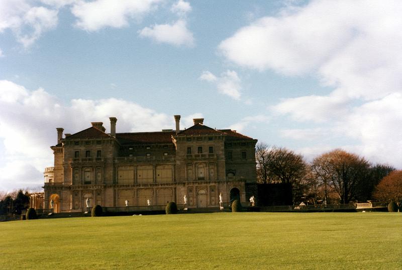 06 The Breakers is a Vanderbilt mansion located on Ochre Point Avenue, Newport, Rhode Island, on the Atlantic Ocean. The Breakers was built as the Newport summer home of Cornelius Vanderbilt II, a member of the wealthy United States Vanderbilt family. Designed by renowned architect Richard Morris Hunt and with interior decoration by Jules Allard and Sons and Ogden Codman, Jr., the 70-room mansion boasts approximately 60,000 sq. ft. of living space. The home was constructed between 1893 and 1895 at the then-astronomical cost of more than seven million dollars. The Ochre Point Avenue entrance is marked by sculpted iron gates and 30-foot high walkway gates are part of a twelve-foot-high limestone and iron fence that borders the property on all but the ocean side. The 250' x 150' dimensions of the five-story mansion are aligned symmetrically around a central Great Hall.