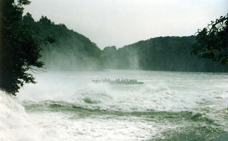 x-03 A boatload of visitors heads toward the central rock. The photo is taken through mist, but the boat isn't in mist, and it's also in calm water in the rock's lee.